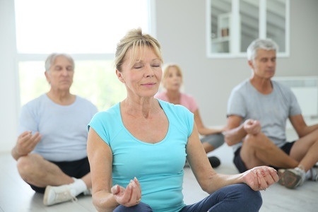 45367102 - group of senior people doing yoga exercises