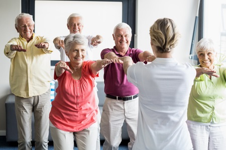 58319395 - seniors doing exercises in a retirement home