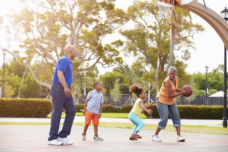 grandparents and grandchildren playing basketball together