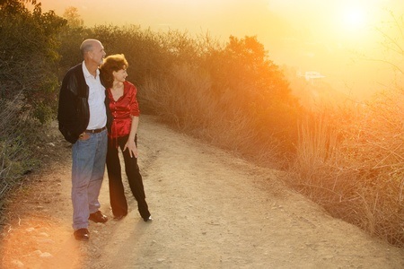 mature couple enjoying sunset on a trail outdoors.