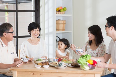 happy asian chinese multi generations family dining at home.