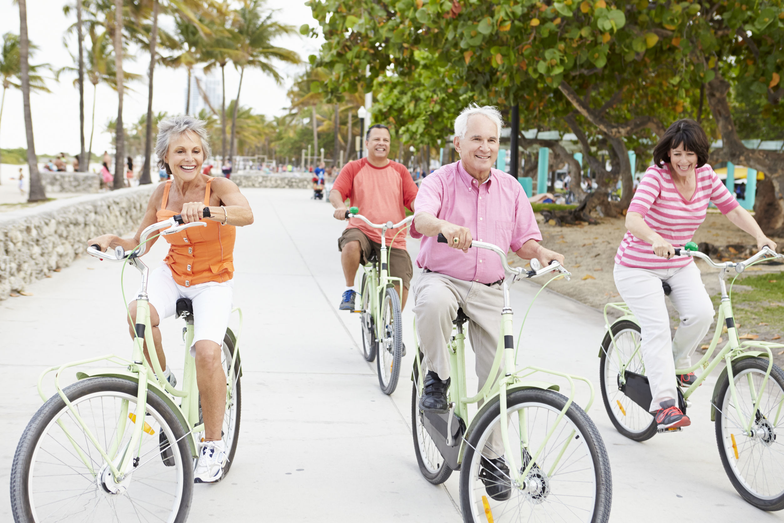 group of senior friends having fun on bicycle ride