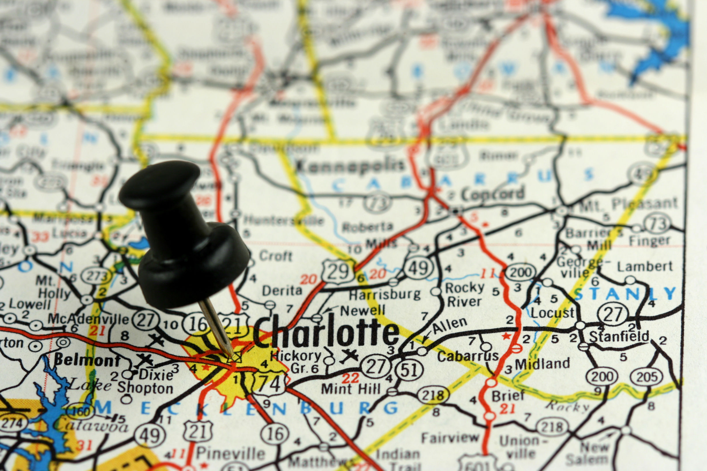 Charlotte, North Carolina. Push pin on an old map showing travel destination (1)