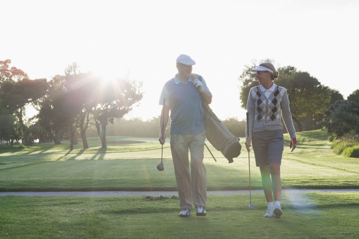 Senior couple walking at a golf course