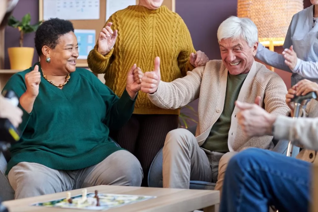 A group of friends gathered around a table, enjoying a lively board game together. Laughter fills the room.