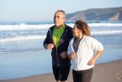 Couple of seniors jogging at the beach