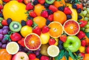 Colorful assortment of water-rich fruits including watermelon, strawberries, oranges, kiwi, lemons, grapes, and blackberries — perfect for staying hydrated in summer.