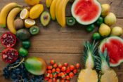 Colorful assortment of water-rich fruits including watermelon, strawberries, oranges, kiwi, lemons, grapes, and blackberries — perfect for staying hydrated in summer.