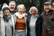 A diverse group of seniors enjoying a lighthearted moment, laughing together happily.