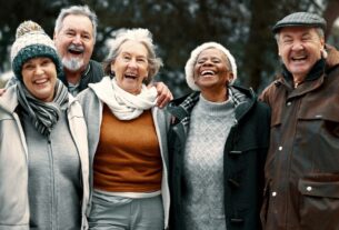 A diverse group of seniors enjoying a lighthearted moment, laughing together happily.
